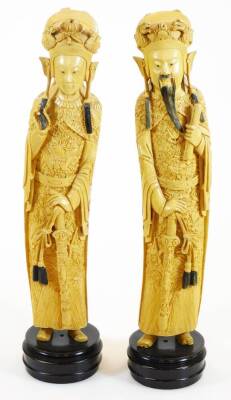 A pair of faux ivory figures, formed as a lady and gentleman in flowing robes on fixed bases, 45cm high. (2)