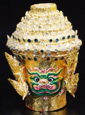 A Thai face mask, heavily decorated with mirrored glass sections set with tusks and with fierce facial expressions, 30cm high, and two others, etc. (a quantity) - 10