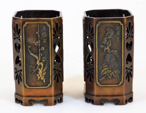 A pair of Chinese octagonal pierced soapstone brush pots, alternate signed panels decorated in relief with flowers, the interceding panels pierced with stylised designs, 13cm high.