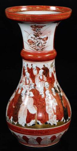 A Japanese porcelain Kutani bulbous vase, with everted neck, decorated red, black and orange with a band of sages within floral and lappet borders, Meiji period, 30cm high.