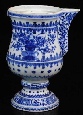 A 18thC blue and white porcelain ewer, with shaped spout, bellied circular body, inverted stem and domed foot, profusely decorated with vases of flowers in upper geometric pattern, with handle lacking, 25cm high. - 3