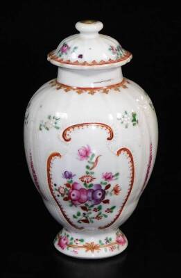 An 18thC Chinese export famille rose shaped teapot stand, decorated with various flower heads within geometric floral banding, 15cm wide, a matching teapoy and cover, 18thC, and a Chinese blue and white porcelain saucer, probably 18thC. (3) - 3