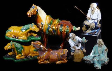 A Chinese Tang style figure of a horse, in standing pose, polychrome decorated mainly in orange glazes, unmarked, 33cm high, two similar designed recumbent horses, a buffalo figure and three 20thC Chinese figures of fisherman. (3)