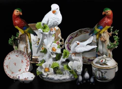 A pair of 20thC Dresden porcelain parrot figures, each polychrome decorated on tree bow bases, marked beneath, 33cm high, an early 19thC hand painted dish decorated with summer flowers, Continental porcelain bird figure group, a 19thC French porcelain jar
