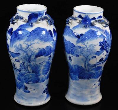 A pair of late 19thC Chinese porcelain baluster vases, the upper sections moulded with chitin (baby dragons), the main body decorated with fisherman, farmers, mountains and trees, four character Kangxi marks beneath, 25cm high. (2)