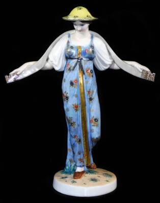 A Russian State porcelain factory figure by S S Pimenov of Vodonoski, shape 1922, polychrome decorated, formed as a lady in flowing robes with gilt highlights, marked with hammer and sickle beneath, 27cm high.