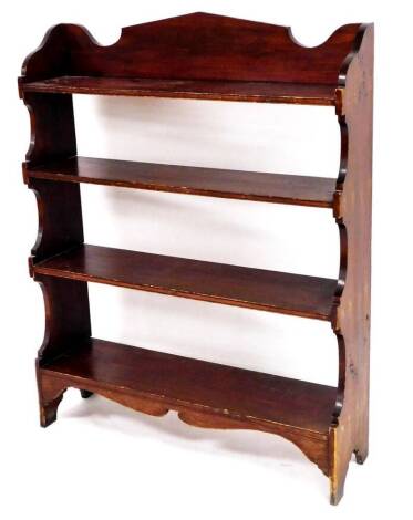 An Edwardian stained pine bookcase, of rectangular form with shaped sides and plain shelves, on shaped stiles, 102cm high, 82cm wide, 23cm deep.