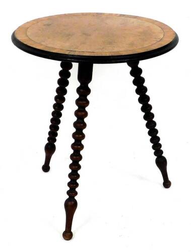 A Victorian occasional table, with circular burr walnut top, with radial crossbanding, ebonised moulded edge and three bobbin turned legs, 55cm diameter.