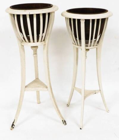 A graduated pair of Regency style planters, each with domed inserts and slatted upper sections on saber legs joined by a triangular under tier, 90cm high, 41cm diameter, etc. (2)