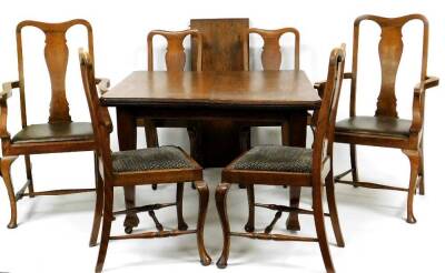 An early Edwardian oak dining room suite, comprising table with canted top on square tapering legs with leaf, when extended 72cm high, 142cm wide, 98cm deep, and a set of six (4+2) dining chairs with various seat coverings on cabriole front pad legs joine