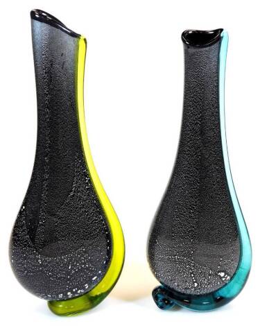 A matched pair of studio Our Glass vases, with turquoise and yellow glass sections, and a black and speckled ground, signed, 39cm high. (2)
