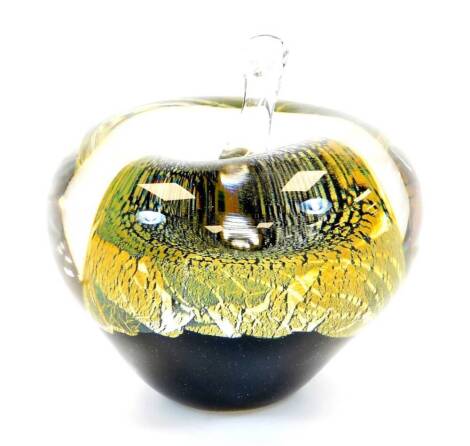 A 20thC Our Glass apple, in gilt black and green colour way, dated 2011, 9cm high.