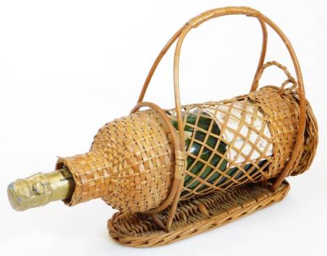 A Vintage bottle of Moet and Chandon champagne, in a wicker carafe, 89cm high.