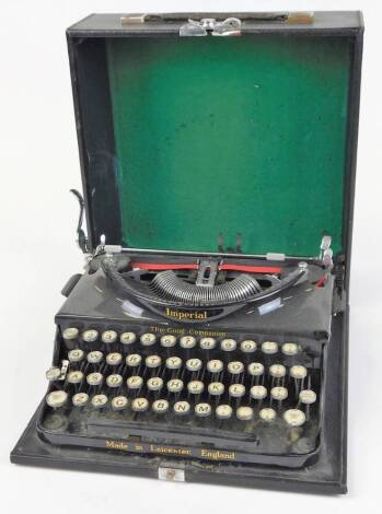 A vintage Imperial portable typewriter, in black trim, with pressed case, 14cm high.