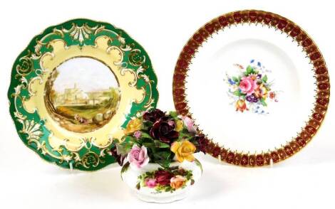 An early 20thC hand painted Coalport plate, Isola Sora, with a raised floral border on green ground, 23cm wide, a Royal Crown Derby cabinet plate and a Royal Albert Old Country Roses posy. (3)