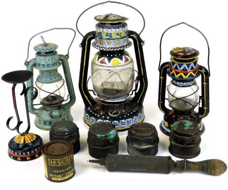 Various decorative Tilly lamps, to include one painted with repeating pattern of flowers and triangles, 32cm high, brass hub caps, etc. (a quantity)