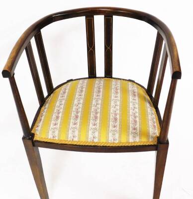 An Edwardian mahogany and boxwood strung tub chair, with vertical back splats, overstuffed seats, in Regency style stripe material, on curved square tapering legs, 77cm high. - 2