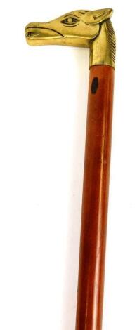 A walking stick with brass horse head top, and plain tapering stem with rubber end, 86cm high.