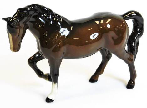 A 20thC Beswick trotting horse right leg raised, printed marks beneath, 15cm high.