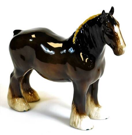 A 20thC Beswick pottery shire horse standing, 21cm high.