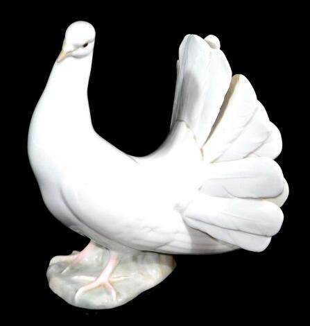 A 20thC Lladro figure of a dove, printed marks beneath, 20cm high.