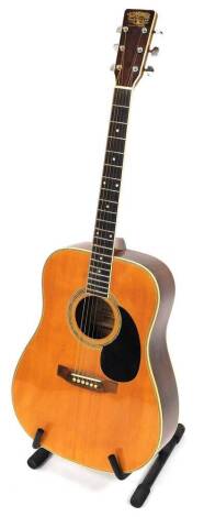 A Tanglewood Guitar Company six sting acoustic guitar, chrome tuning knops, 112cm high, on stand.