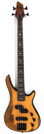 A four string bass electric guitar, with shaped tuning knops, 108cm wide.