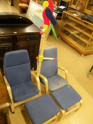 A pair of child's armchairs with loose cushions and matching