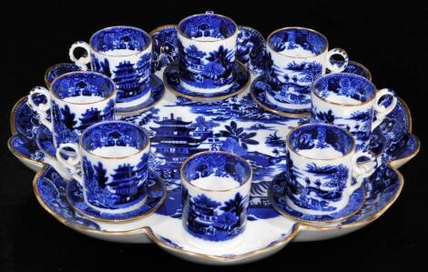 A miniature Copeland blue and white service, comprising coffee cans and seven saucers, on a shaped stand, marks beneath, 28cm wide.