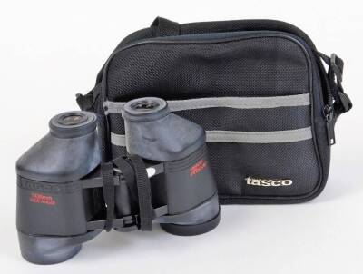 A pair of Tasco Japanese in focus binoculars, 13cm high, in fitted case.