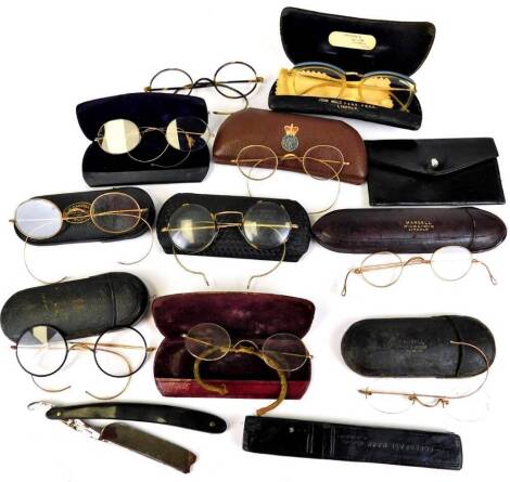 Various vintage spectacles, a pair of tortoise shell examples with gold coloured curved side bars, 11cm wide, another pair of gilt coloured examples, other unmarked gilt coloured examples, cases, etc. (a quantity)