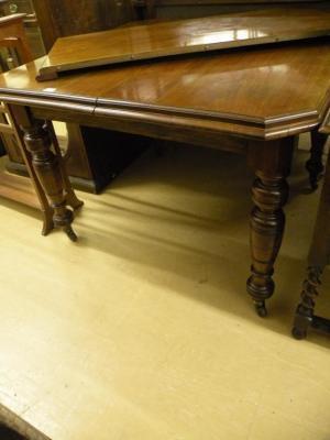 A Victorian walnut extending dining table