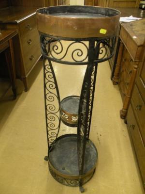 An Arts & Crafts style copper and wrought iron three-tier plant stand