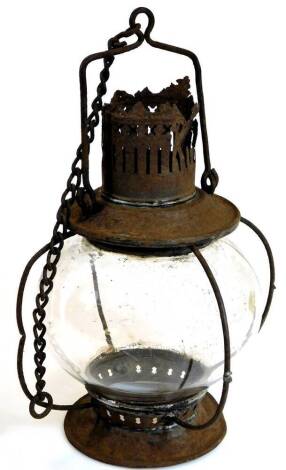 An early 20thC cast metal and glass hanging lantern, with bulbous shade and a wirework and chain hanger, the main body 35cm high.