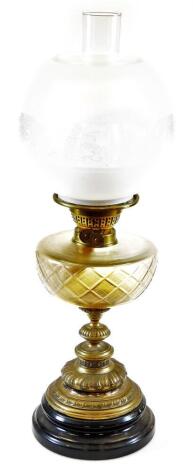 An early 20thC oil lamp, with frosted and clear glass shade, shaped glass reservoir, turned stem and domed foot with plain funnel, 61cm high.