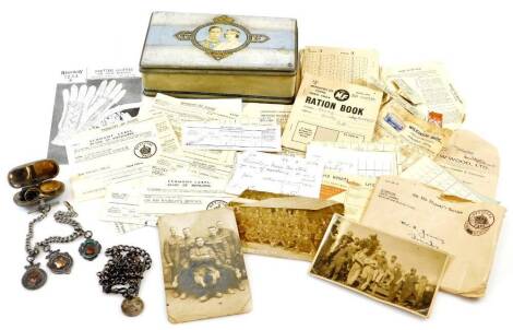 Various early 20thC and later postcards, ration book, silver watch chain, plated double sovereign and a half sovereign case, various other related ephemera, ration books, etc., contained in a Carr's biscuit tin, 20cm wide.