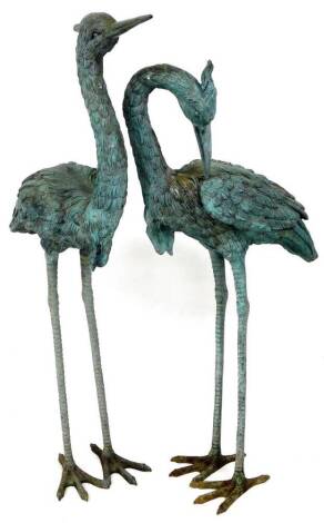 A pair of Leonardo Rossi type bronze garden heron ornaments, one with neck arched, unsigned, 103cm high. (2)