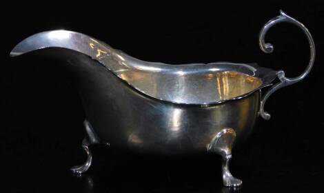 A George V silver sauce boat, with flared rim, flying S scroll handle and triple hoof feet, Chester 1916, 10cm high, 5½ oz.