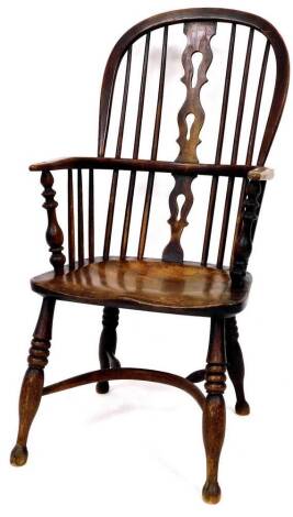 A 19thC ash and elm high back Windsor chair, with pierced Retford style back splat, on triple reed turned legs, joined by a crinoline stretcher, 102cm high.