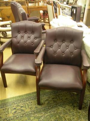 A pair of burgundy leather upholstered open armchairs