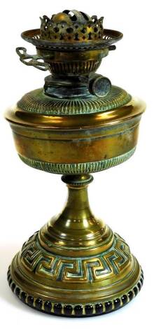 An early 20thC brass oil lamp base, with a Greek key decoration to the lower section, 36cm high.