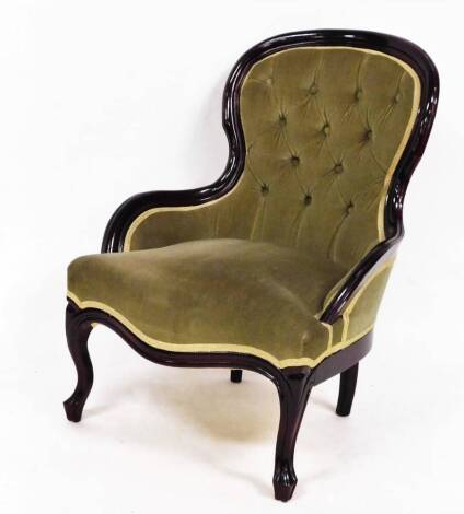 A 20thC open spoon back nursing chair, with overstuffed studded back, serpentine seat and cabriole front legs, 83cm high.