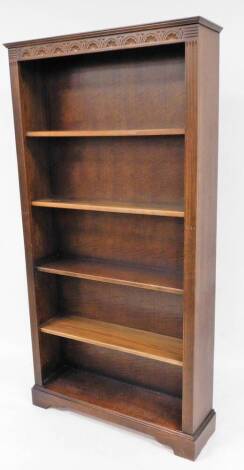 A 20thC oak open bookcase, of rectangular form with carved frieze and removable shelves, on a block base, 198cm high, 101cm wide, 28cm deep.