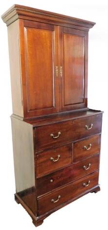 An early 19thC mahogany secretaire bookcase, the dentil top raised above a pair of panelled doors, and a cock beaded secretaire raised above two further short deep drawers and two long drawers, each with swan neck handles, on ogee bracket feet, 225cm high