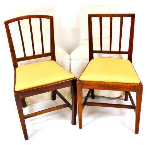 Four Sheraton style elm kitchen chairs, each with vertical splats on square tapering front supports joined by H stretchers, in later white material, with drop in seats with cream slip covers, 87cm high. (4, AF)