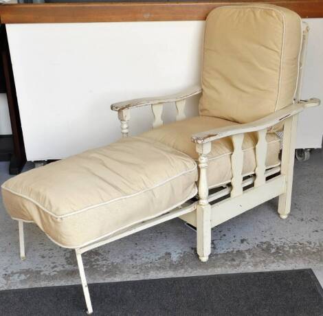 A painted metal and wooden adjustable chair, with mesh work back shaped arms, with articulated action, on turned front supports, terminating in block legs and compressed bun feet, 103cm high.