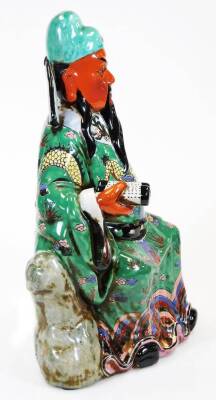 A Chinese porcelain figure of an emperor or immortal, holding a scroll, decorated in yellow, green, blue, purple coloured enamels, unstamped, 43cm high. - 2