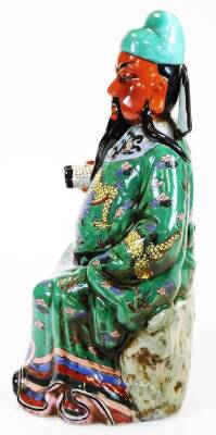 A Chinese porcelain figure of an emperor or immortal, holding a scroll, decorated in yellow, green, blue, purple coloured enamels, unstamped, 43cm high. - 4