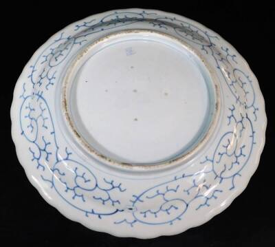 A Japanese blue and white porcelain charger, with a foliate rim, decorated in underglaze blue with a floral and leaf design, the reverse with seal within scrolling border, Meiji period, 47cm wide. - 3