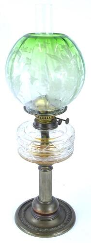 A Victorian brass oil lamp, with reeded column and leaf cast base, with a green globular etched floral shade, the mechanism AF, the lamp base 37cm high, the shade 18.5cm high.
